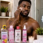 Best Rose Water Toners in Nigeria (2026): Top 10 Products Reviewed African man applying rose water toner directly on his face for glowing, hydrated skin with top rose water toners in Nigeria displayed on a bathroom counter.