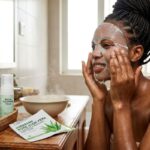 Best Aloe Vera Sheet Masks in Nigeria for Soothing and Hydrating Skin African woman applying an aloe vera sheet mask during a skincare routine for soothing and hydrating skin in Nigeria.