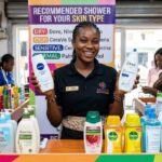 Nigerian cosmetic store salesperson advertising top shower gels for different skin types, including Dove, NIVEA, CeraVe and other popular brands.